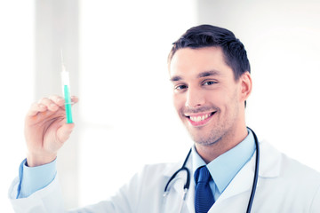 male doctor holding syringe with injection