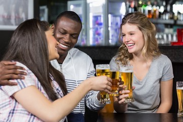 Portrait of happy friends having a drink