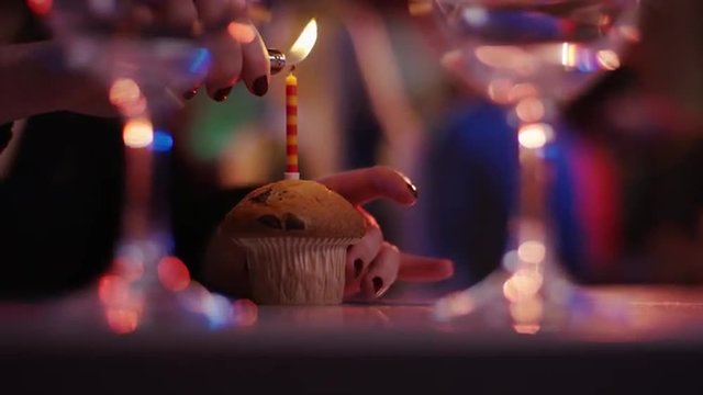 blond girl is beeing congratulated and gets birthday cake at club