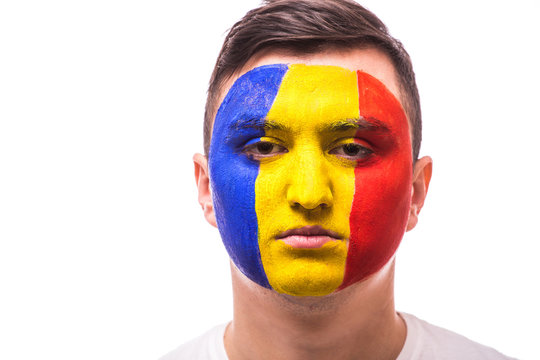 Unhappy and Failure of goal or lose game emotions of Romanian football fan in game supporting of Romania national team on grey background. European 2016 football fans concept.