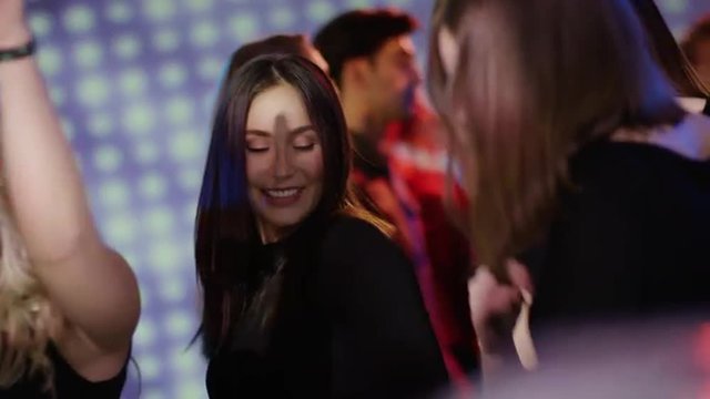 dark haired girl dancing at club