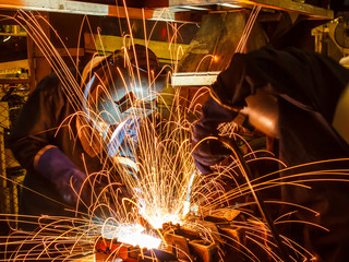 Team welder Industrial automotive part in factory