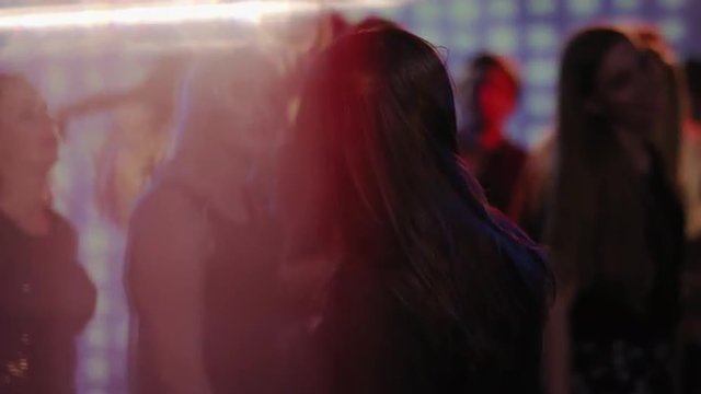 attractive dark haired girl dancing on dancefloor at club