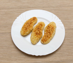 nuggets, breaded in a potato on a white plate