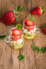 Homemade fruit salad in jars on a wooden background