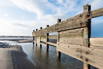 cleveleys, england, 02/17/2016, A rustic, weathered wooden sea defence wall, showing signs of damage...