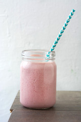 Strawberry smoothie on wooden 
