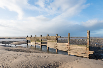 cleveleys, england, 02/17/2016, A rustic, weathered wooden sea defence wall, showing signs of damage...