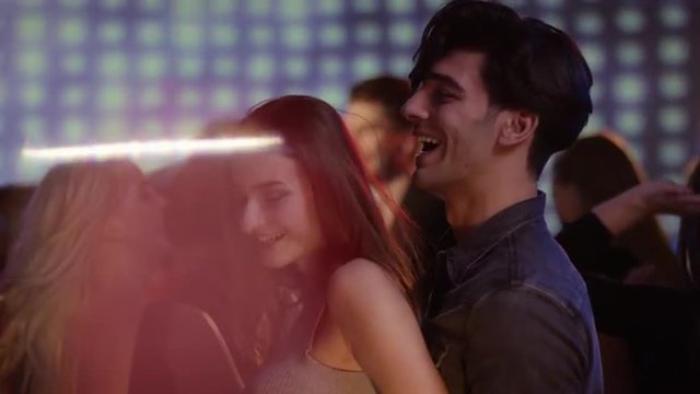 young attractive couple on dancfloor at club having fun