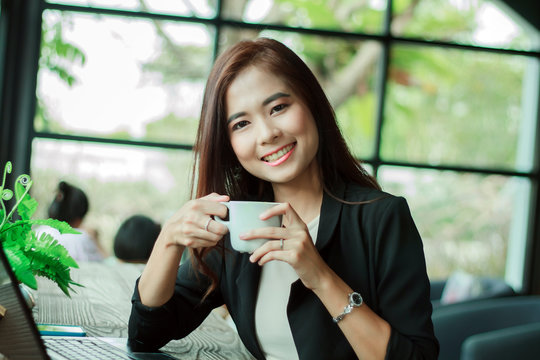 Asian business woman is working and drinking coffee,soft focus
