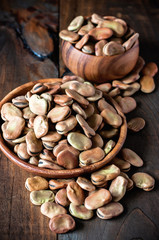 Fava beans in wooden bowls. Rustic style. Toned image. Selective focus