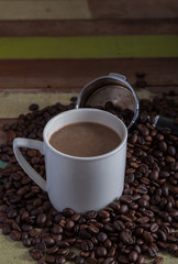 White coffee cup with beans background