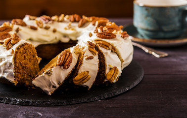 Spicy carrot and orange cake on a dark wooden background 