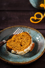 Spicy carrot and orange cake on a dark wooden background 