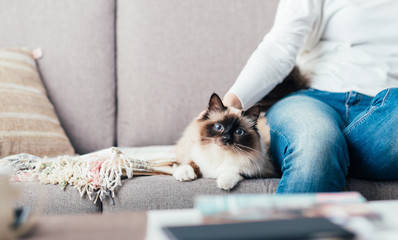 Woman cuddling her cat