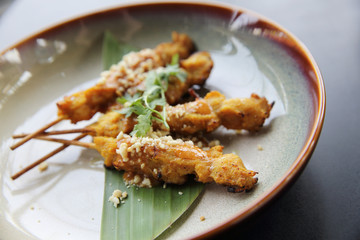chicken satay, sate ayam and lontong with peanut sauce