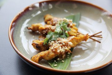 chicken satay, sate ayam and lontong with peanut sauce