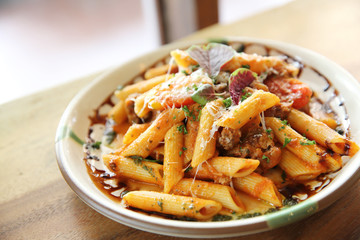 Penne pasta in tomato sauce with meatballs