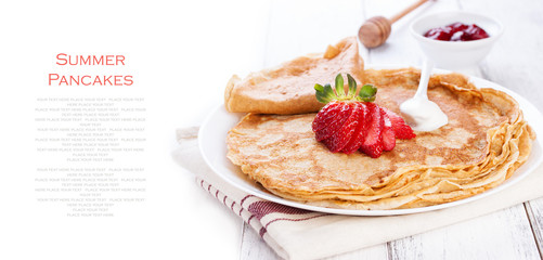 Staple of wheat golden yeast pancakes or crepes, traditional for Russian pancake week, with fresh strawberry on a wooden table on a white background with place for text or copy space, top view.
