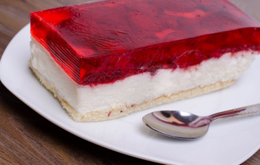 A cup of cappuccino coffee with slice of  cake