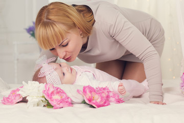 Mother is kissing her daughter 