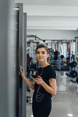 Fototapeta na wymiar Girl with headphones at the gym