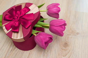 Three tulip and red box for gift in form of heart