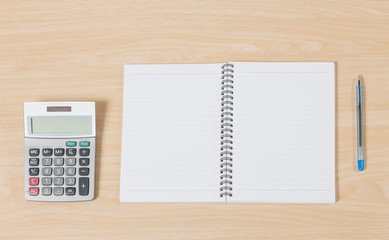 notebook, pen and calculator on wood