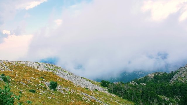 Cloudy weather view of the highest peaks of the Lovcen mountain national park in southwestern Montenegro, paning from the left to the right.