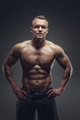 Fototapeta na wymiar Awesome muscular guy showing his body.
