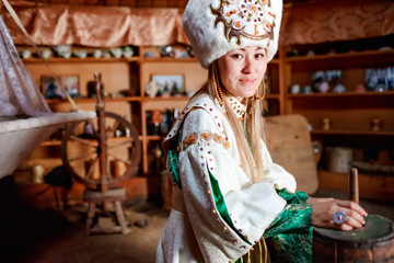 Young woman in traditional yurt dwelling.