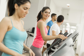 Fototapeta premium Young woman training in the gym