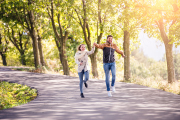 Fototapeta premium Couple in love in park on a walk, running