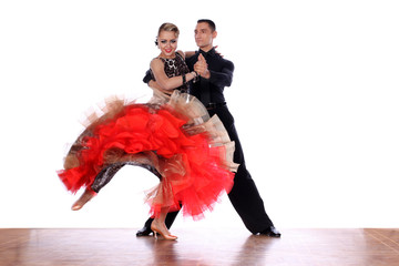 Latino dancers in ballroom against white background