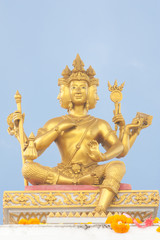 Fototapeta premium Hinduism Golden Brahma statue under blue sky