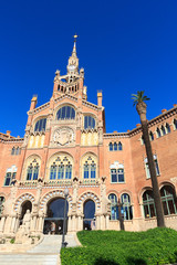 Fototapeta na wymiar Hospital de Sant Pau and palm tree in Barcelona, Spain