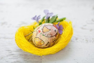 Colorful homemade easter eggs in nest.