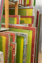 Obraz na płótnie Canvas Silk screen printing screens stored in a wooden rack ready for printing.