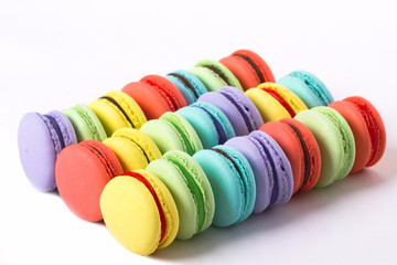 collection of colorful French macarons are next to each other