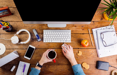 Business person working at office desk wearing smart watch