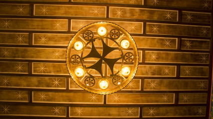 forged chandelier on wooden stelы with stars