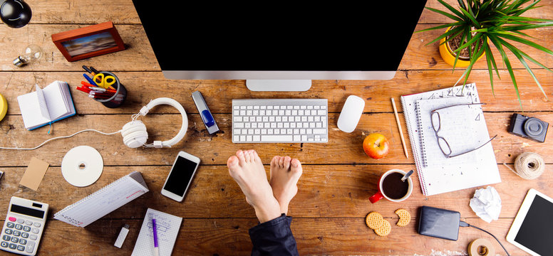 Businessman Working In His Office With Feet On Desk