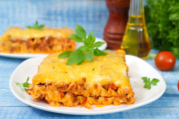 Classic Lasagna with bolognese sauce on a wooden background. Italian food