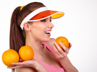 Beautiful close-up young woman with oranges. Healthy food concep