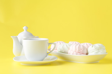 Easter table setting with holiday decor on yellow background