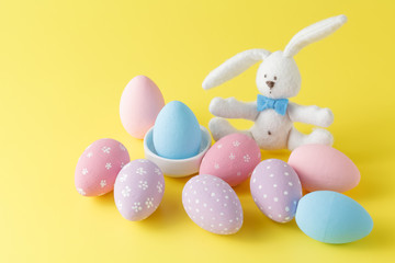 Easter bunny with egg on yellow background