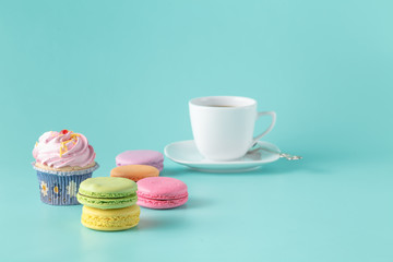 Pastel color macaroon with coffee on aquamarine background