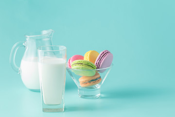 colored macaroons on aquamarine background