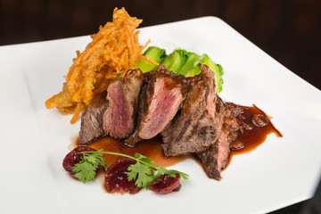 Flame grilled ,rare kangaroo steak loin, served with pak choi and a red wine sauce