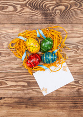 Blank, greeting easter card with handmade easter eggs, nest